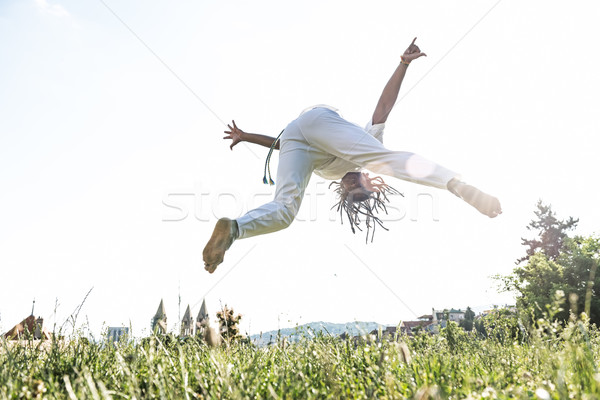 Capoeira woman, awesome stunts in the outdoors Stock photo © Geribody