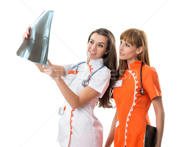 два медсестры смотрят рентгеновский изображение врач Сток-фото © Geribody
