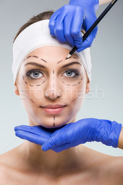Beautiful woman with plastic surgery, depiction, plastic surgeon hands Stock photo © Geribody