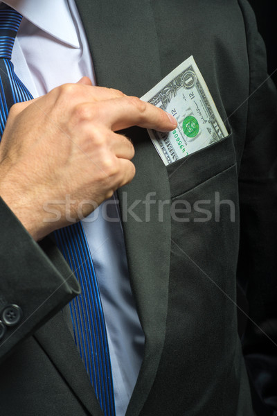 Businessman pulling their money out of pocket Stock photo © Geribody