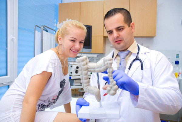Doctor in the intestinal system shows the patient Stock photo © Geribody