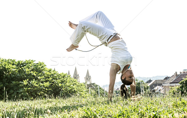 Capoeira woman, awesome stunts in the outdoors Stock photo © Geribody