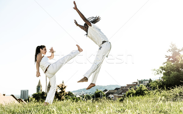 Pair of capoeira performers doing a kicking Stock photo © Geribody