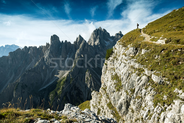 Stock photo: Italy, Dolomites - Man hiker standing very far from the edge of the barren rocks 