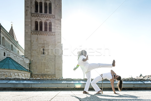 Pair of capoeira performers doing a kicking Stock photo © Geribody
