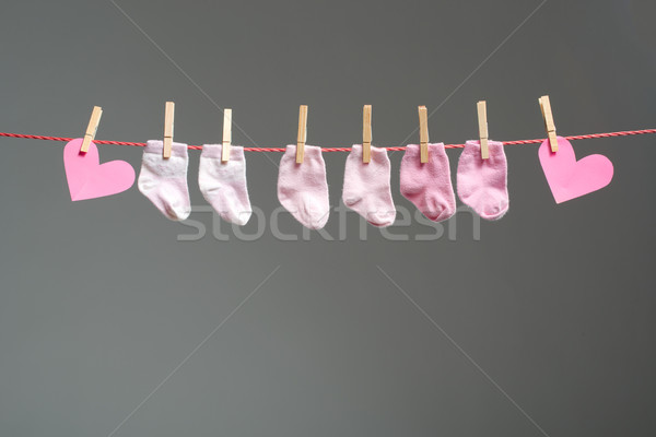 baby girl socks and paper heart on the clothesline Stock photo © Geribody