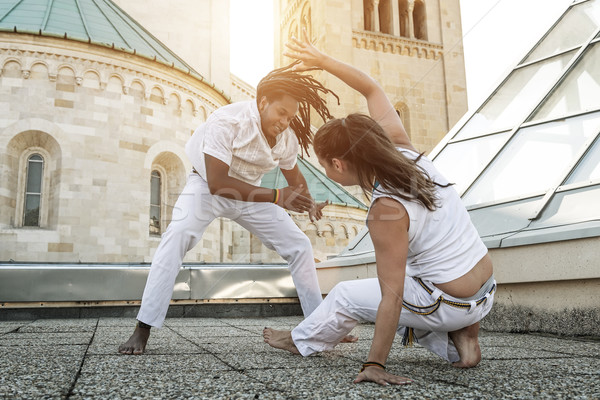 Young pair capoeira partners performing kicks outdoor Stock photo © Geribody
