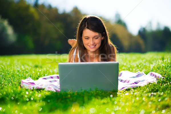 Cute młodych kobiet laptop trawy portret Zdjęcia stock © Geribody