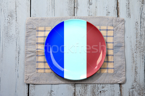 Empty plate with French flag on light blue wooden background Stock photo © gigra