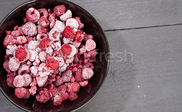 Stock photo: Frozen raspberries on dark wooden background