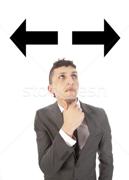 Young man making a choice with arrows isolated on white background Stock photo © gigra