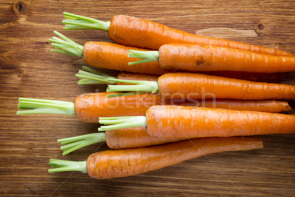 Fresh carrots on the wooden background. Stock photo © gitusik