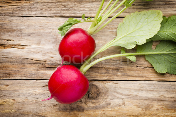 Stock photo: Radish on the wooden table.