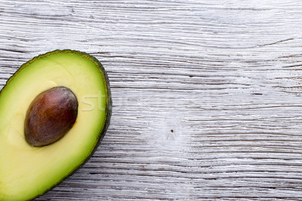 Avocado parts on the wooden table. Stock photo © gitusik