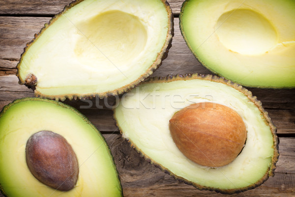 Stock photo: Avocado parts on the wooden table.