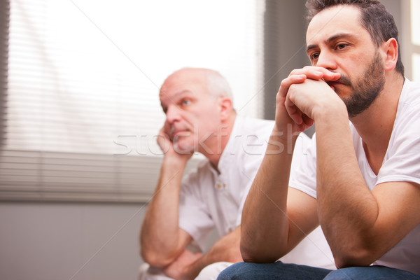 men concerned about something in a living room Stock photo © Giulio_Fornasar