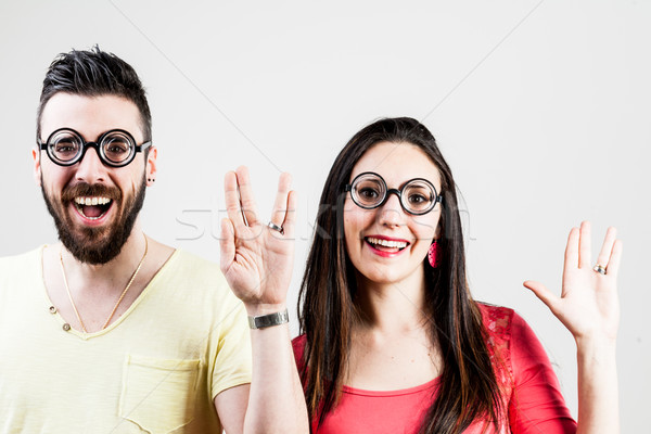 Stock photo: nerd couple doing the trekkie salutation