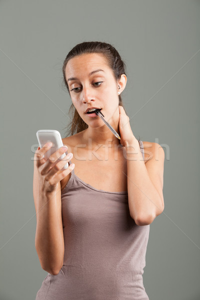 Attractive young woman reading an sms on a mobile Stock photo © Giulio_Fornasar