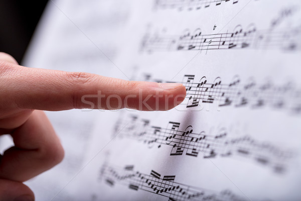 Stock photo: notes on a musical score spotted by finger