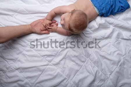 Newborn infant crawling on a white bed Stock photo © Giulio_Fornasar