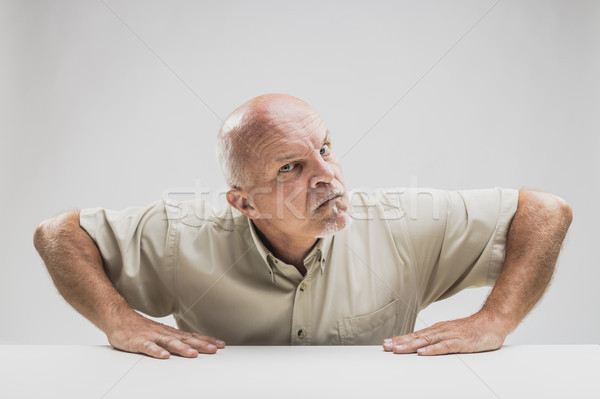 Stock photo: Skeptical disbelieving senior man glaring