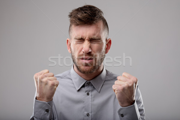 Stock photo: Man deep in concentration screwing up his eyes
