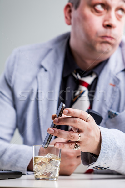Stock photo: manager putting his smartphon on alcohol
