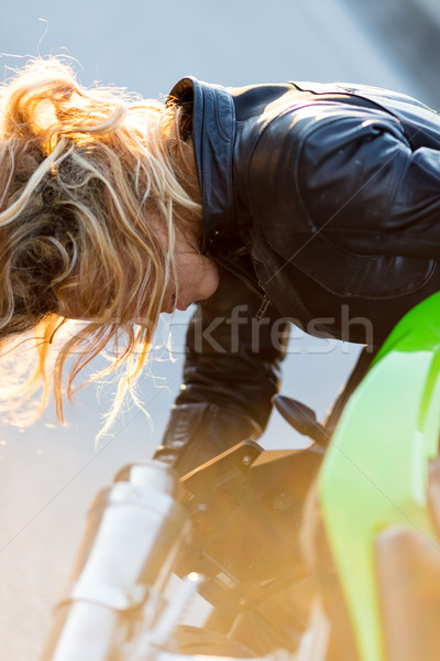 woman setting up her motorcycle to run Stock photo © Giulio_Fornasar