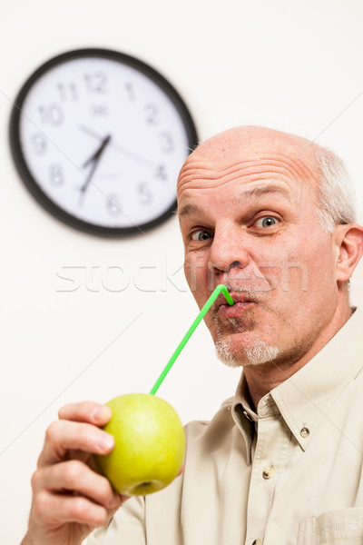 Bearded mature man sipping juice from apple Stock photo © Giulio_Fornasar