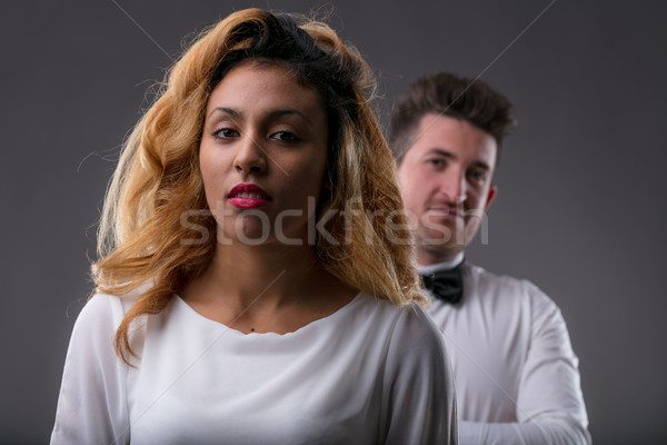 thoughtful woman looking to you with a man controlling her Stock photo © Giulio_Fornasar