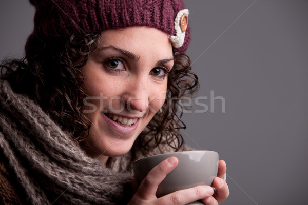 smiling woman with a mugful of a hot drink Stock photo © Giulio_Fornasar