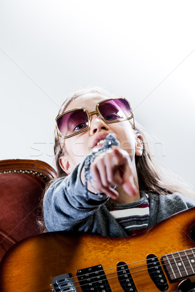 little girl playing as a guitar hero rockstar Stock photo © Giulio_Fornasar