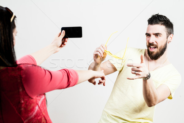 thrilled couple taking mobile photographs and selfies Stock photo © Giulio_Fornasar