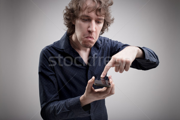 Telefon nefret ciddi adam endişeli hayal kırıklığına uğramış Stok fotoğraf © Giulio_Fornasar