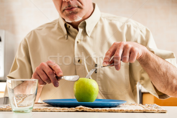 Obscured man slicing apple over blue plate Stock photo © Giulio_Fornasar
