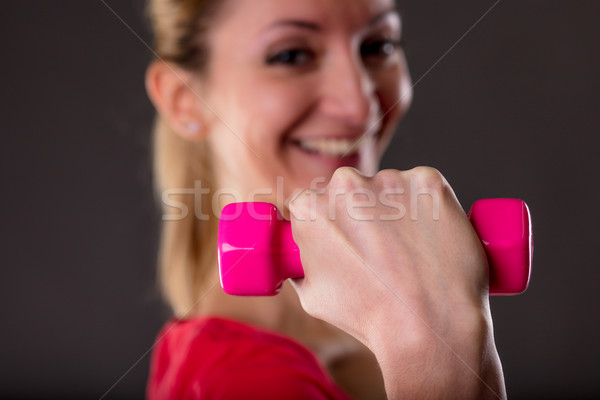 Focus sollevamento pesi donna sorridente piccolo rosa bilanciere Foto d'archivio © Giulio_Fornasar