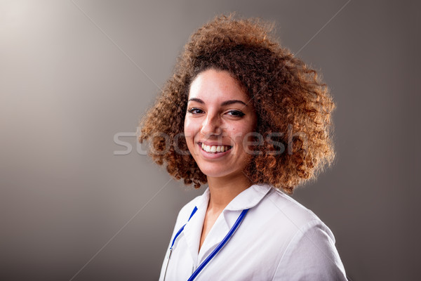 reassuring smile of a curly doctor Stock photo © Giulio_Fornasar