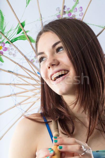 beautiful girl nicely smiling with a blue Eastern parasol Stock photo © Giulio_Fornasar