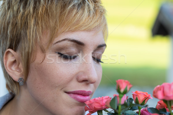 real woman smelling flowers outdoors Stock photo © Giulio_Fornasar
