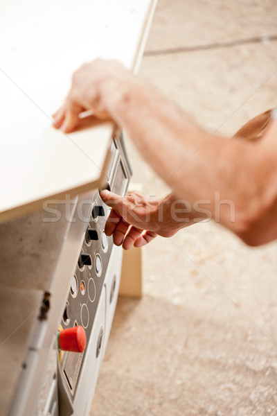 carpenter's hand on control knobs Stock photo © Giulio_Fornasar