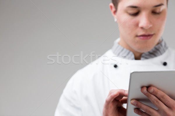 young chef ordering online with his tablet Stock photo © Giulio_Fornasar