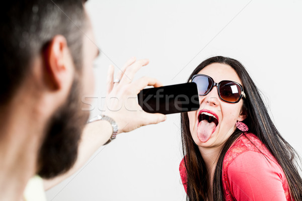 thrilled couple taking mobile photographs and selfies Stock photo © Giulio_Fornasar