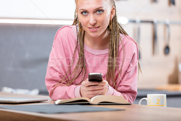 Attractive young blond woman holding a smartphone Stock photo © Giulio_Fornasar