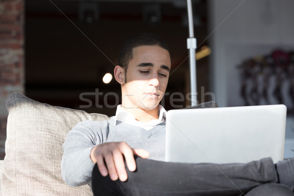 Man on sofa with laptop Stock photo © Giulio_Fornasar