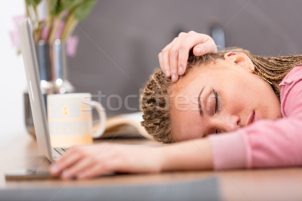 Tired attractive young woman sleeping on a table Stock photo © Giulio_Fornasar