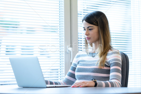 Young woman sitting in front of laptop Stock photo © Giulio_Fornasar