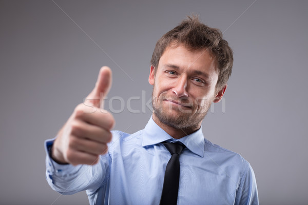 Happy successful man giving a thumbs up gesture Stock photo © Giulio_Fornasar