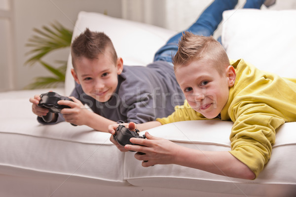 Stock photo: two kids playing video games