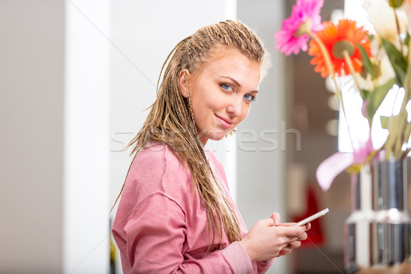 Smiling friendly young woman using a mobile Stock photo © Giulio_Fornasar