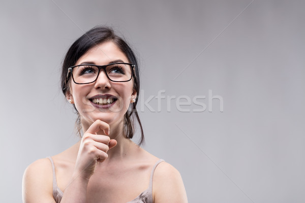 Happy vivacious young woman deep in thought Stock photo © Giulio_Fornasar